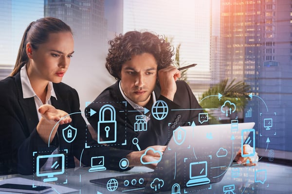 Two thoughtful business people with laptop, blue glowing information protection icons